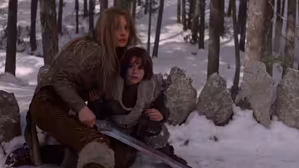 Valeria (Sandahl Bergman) shields a young woman among snow-covered trees