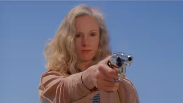 Jennifer Spencer (Sondra Locke) aims a revolver outdoors