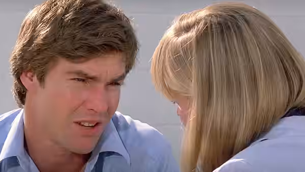 Mike Brody (Dennis Quaid) speaks closely with a blonde woman