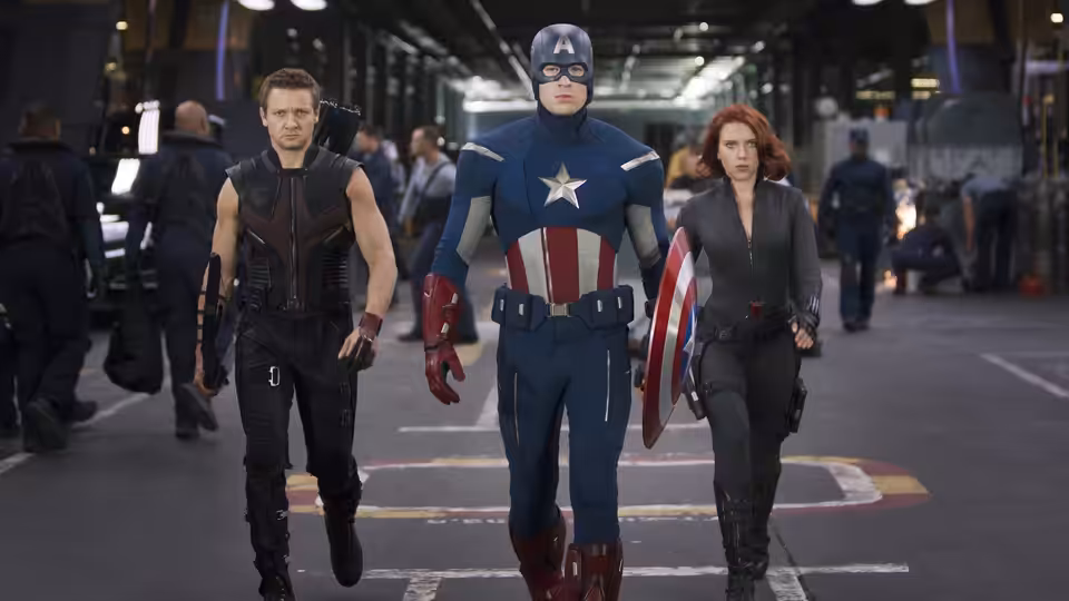 Hawkeye, Captain America and Black Widow walking through an industrial corridor