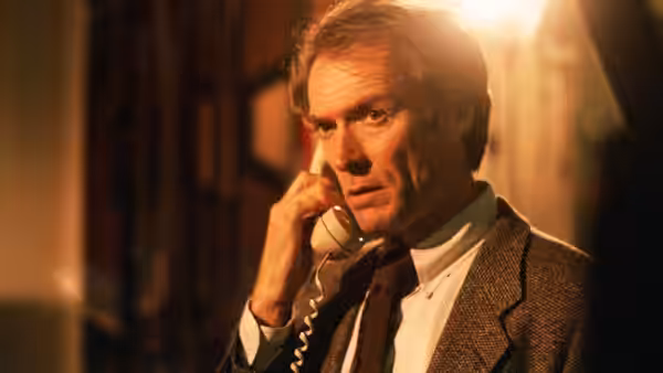Wes Block (Clint Eastwood) holds a telephone receiver to his ear