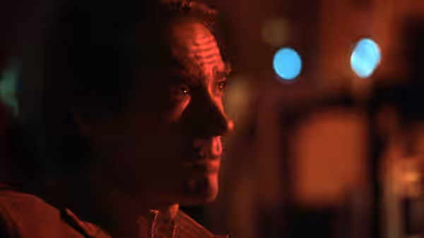 Wes Block (Clint Eastwood) looks into the darkness under red light