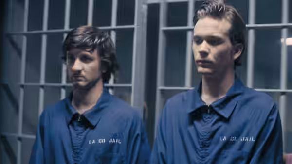 Daulton Lee (Sean Penn) and Christopher Boyce (Timothy Hutton) stand in jail uniforms