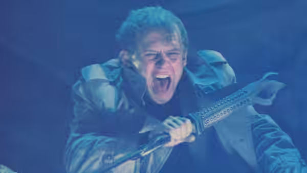 Col. Tom Carlsen (Steve Railsback) shouts while gripping a serrated weapon underwater
