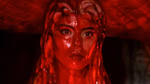 The Space Girl (Mathilda May) stares ahead, drenched in red light