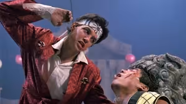 Daniel (Ralph Macchio) raises his fist over Chozen (Yuji Okumoto) during a fight