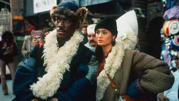 Chandler Jarrell (Eddie Murphy) and Kee Nang (Charlotte Lewis) walk through a crowded market in heavy fur coats