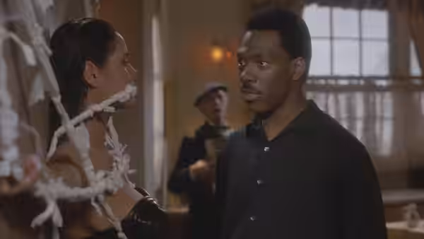 Chandler Jarrell (Eddie Murphy) faces a woman bound with white cords inside a room