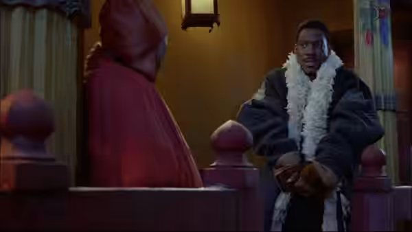 Chandler Jarrell (Eddie Murphy), wrapped in a fur coat, sits opposite a hooded figure