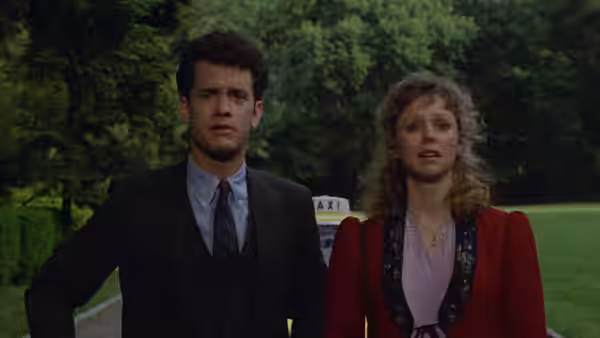 Walter and Anna stand outside near a taxi, looking ahead