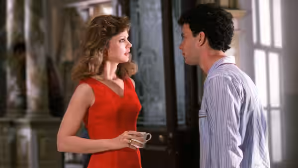 Anna holds a cup as she faces Walter inside the house