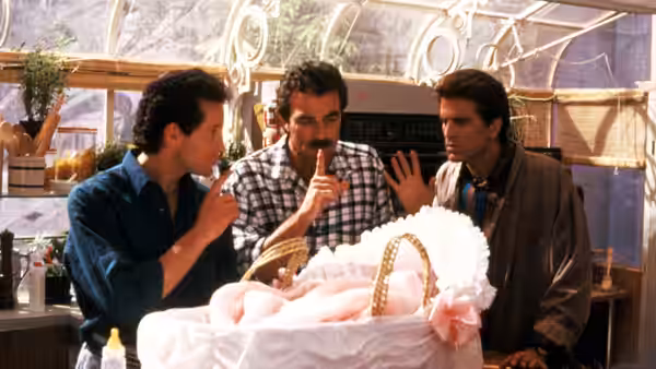 Michael, Peter and Jack gather around the baby in a basket inside a greenhouse