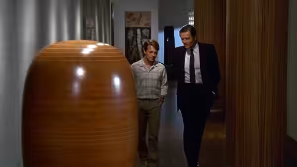 Brantley Foster walks through an office hallway with Donald Davenport