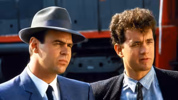 Sgt. Joe Friday (Dan Aykroyd) and Pep Streebeck (Tom Hanks) look offscreen beside a truck