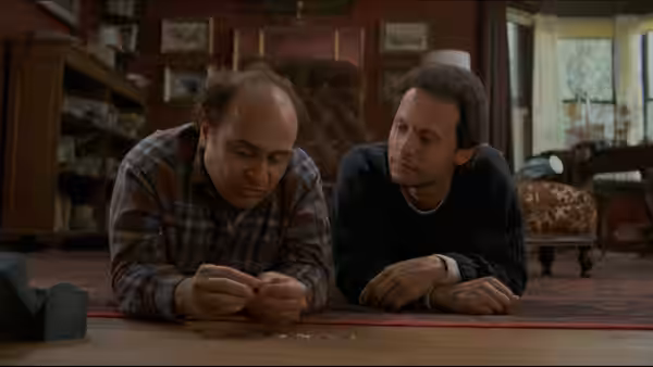 Owen Lift (Danny DeVito) and Larry Donner (Billy Crystal) lie on the floor examining something
