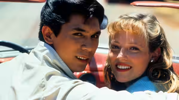 Ritchie Valens (Lou Diamond Phillips) and Donna Ludwig (Danielle von Zerneck) smile together in a car