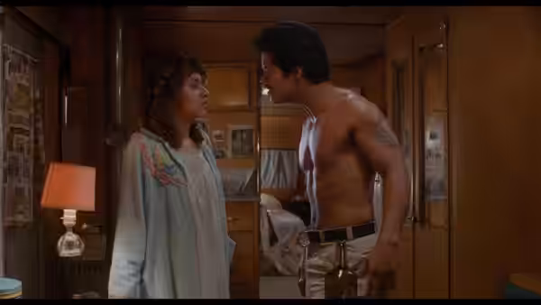 Ritchie Valens (Lou Diamond Phillips) faces a woman in a bedroom