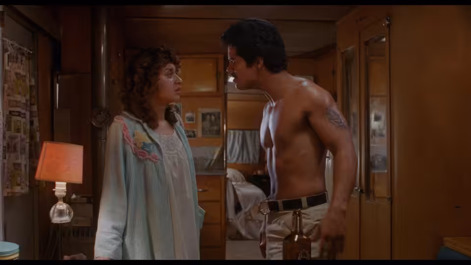 Ritchie Valens (Lou Diamond Phillips) faces a woman in a bedroom