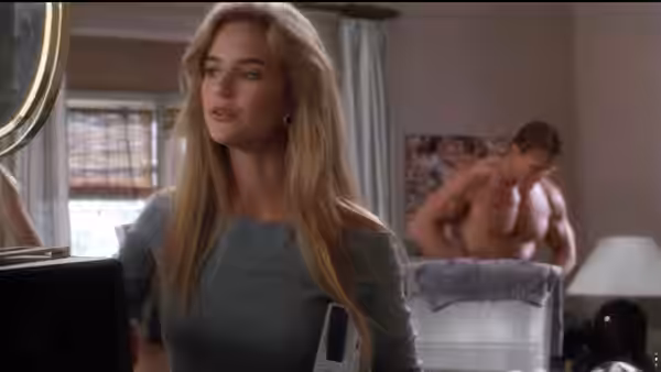 Marnie (Kelly Preston) stands in a bedroom as Julius changes behind her