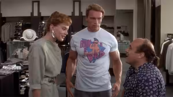Julius stands between a woman and Vincent in a clothing store