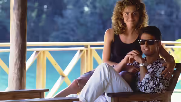 Brian Flanagan and Jordan Mooney relax together on a veranda overlooking the water