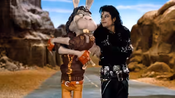 Michael Jackson walks beside a costumed rabbit puppet along a rocky path