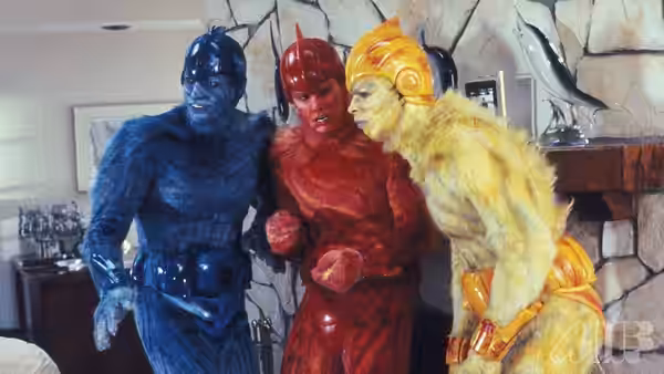 Mac (Jeff Goldblum), Wiploc (Jim Carrey) and Zeebo (Damon Wayans) stand together indoors in colorful alien suits