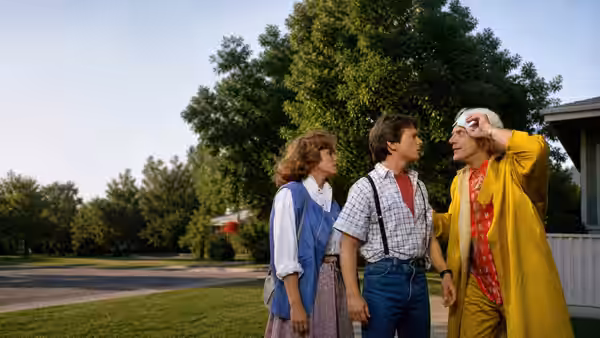 Jennifer (Elisabeth Shue), Marty McFly (Michael J. Fox) and Doc Brown (Christopher Lloyd) stand together outdoors