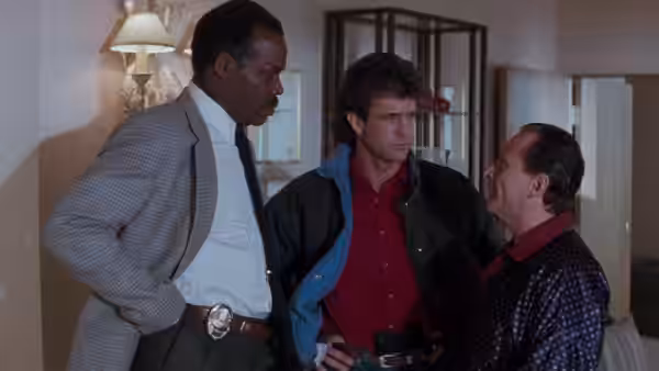 Roger Murtaugh, Martin Riggs and Leo Getz talk inside a house