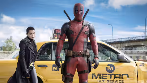 Deadpool (Ryan Reynolds) stands by a taxi with Negasonic Teenage Warhead (Brianna Hildebrand)
