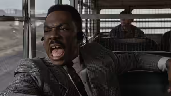 Reggie Hammond (Eddie Murphy) shouts from inside a caged transport vehicle
