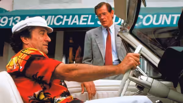 Max Cady (Robert De Niro) drives a convertible while Sam Bowden (Nick Nolte) watches