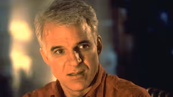 George Banks (Steve Martin) looks ahead in a warmly lit room