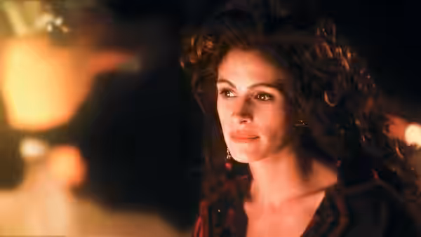 Hilary O'Neil (Julia Roberts) looks toward someone in a warmly lit room