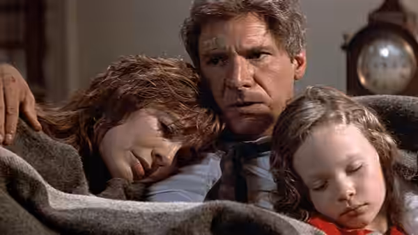 Jack Ryan holds Cathy and Sally as they sleep beneath a blanket