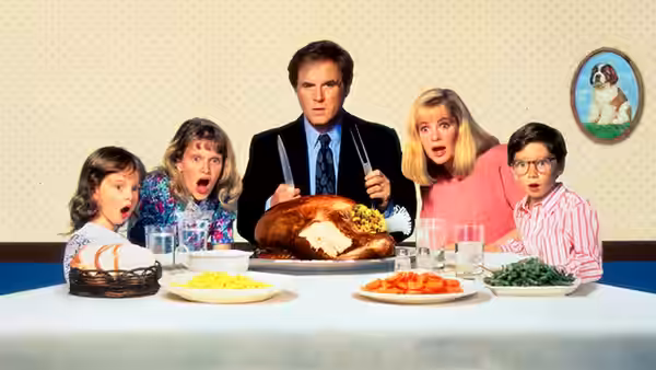 George Newton and his family stare in surprise at a roast turkey dinner