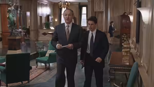 Oliver Lambert (Hal Holbrook) walks through a law office with Mitch McDeere (Tom Cruise)