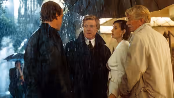 John Gage, Diana Murphy, and David Murphy stand with a man in a rain-soaked doorway