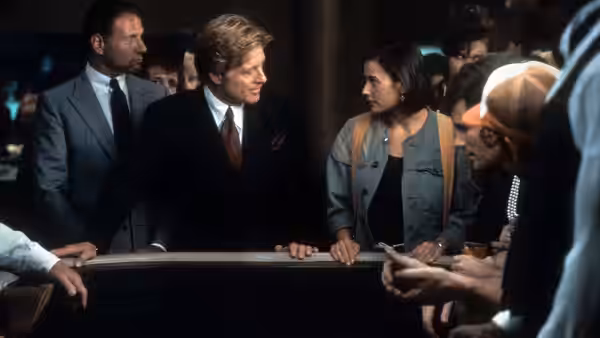 John Gage and Diana Murphy lean over a railing among onlookers