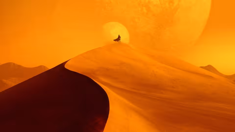 a lone figure atop a massive sand dune under an enormous glowing planet