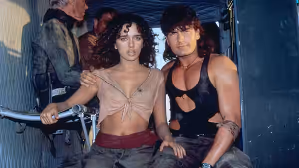 Topper Harley (Charlie Sheen) and Ramada (Valeria Golino) sit together inside a vehicle