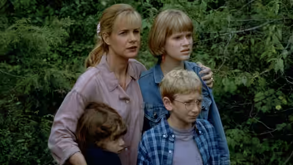 Alice gathers her children close together among the trees