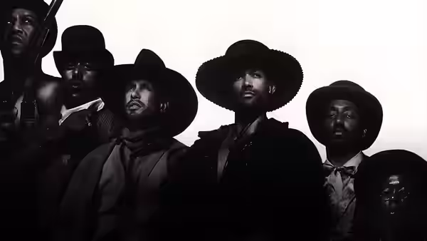A group of Black cowboys in wide-brimmed hats look down toward the camera