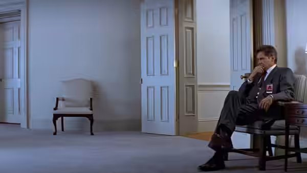 Jack Ryan (Harrison Ford) sits alone in a chair in a spacious office