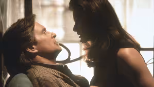 Meredith Johnson leans over Tom Sanders as he reclines in a chair