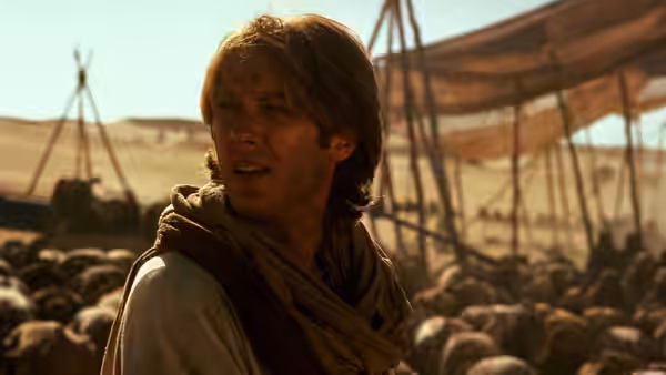 Daniel Jackson (James Spader) looks across a desert camp beneath canvas shelters