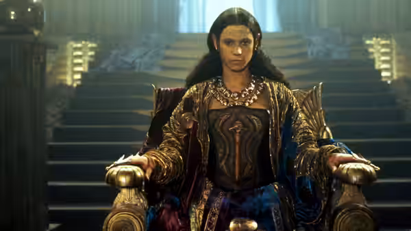 Ra (Jaye Davidson) sits on a throne inside the palace