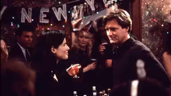 Lucy (Sandra Bullock) and Jack (Bill Pullman) talk at a crowded New Year's party