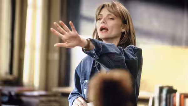 Louanne Johnson (Michelle Pfeiffer) gestures toward her students while teaching in a classroom