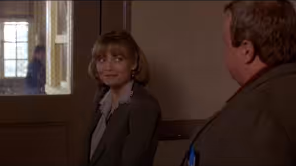 Louanne Johnson (Michelle Pfeiffer) talks with a colleague in a school hallway